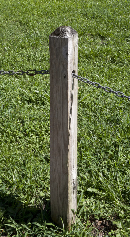 wooden-post-that-has-metal-chain-running-through-it_medium.jpg