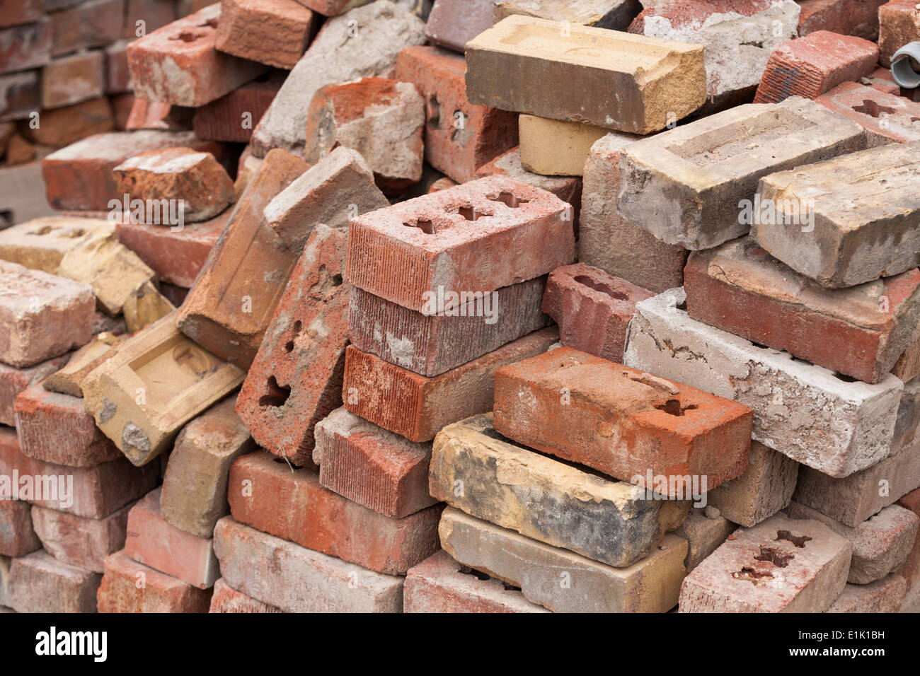 old-bricks-a-pile-of-old-salvaged-bricks-piled-on-the-grounds-of-the-E1K1BH.jpg