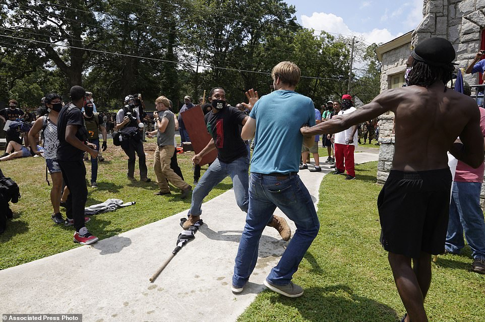 31989888-8631027-Protesters_clash_during_a_demonstration_Saturday_Aug_15_2020_in_-a-67_1597519803260.jpg