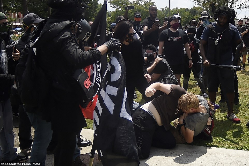 31989892-8631027-A_melee_breaks_out_during_a_protest_Saturday_Aug_15_2020_in_Ston-a-65_1597519767356.jpg